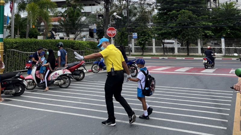 Полицейский переводит ребенка через дорогу. Фото: Phuket Provincial Police